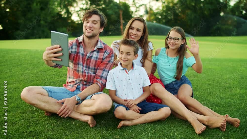 Family using tablet for video chat. Parents and children talking by video call Family using tablet for video chat. Parents and children talking by video call
