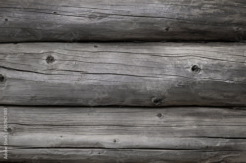 Wood texture. Old grey logs with knots. 