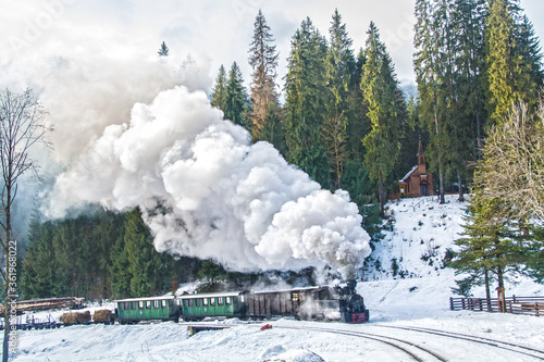 Winter landscape with steam train from Romania