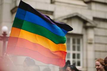 Pride parade with gay rainbow flag in the city