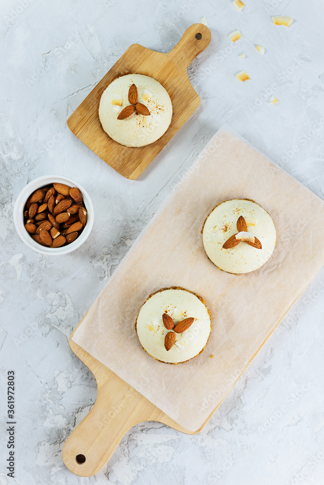 Raw food almond cakes on a wooden board. Vertical orientation, top view. Raw food almond cakes on a wooden board. Vertical orientation, top view.