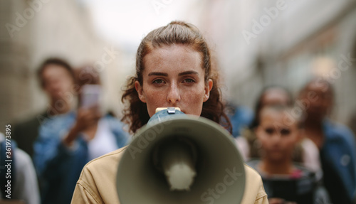 Tela Female activist protesting with megaphone during a strike