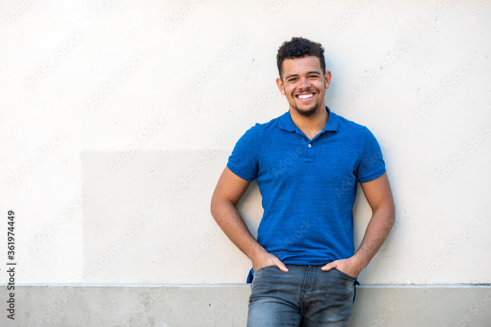 cool young mixed race man smiling against white background