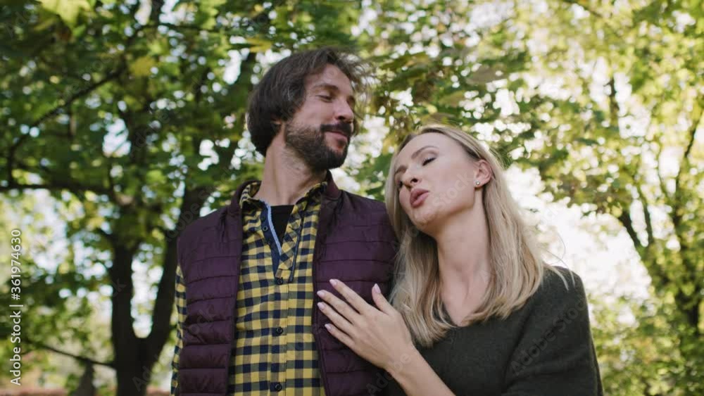 Low angle view of affectionate couple during autumn walk Low angle view of affectionate couple during autumn walk