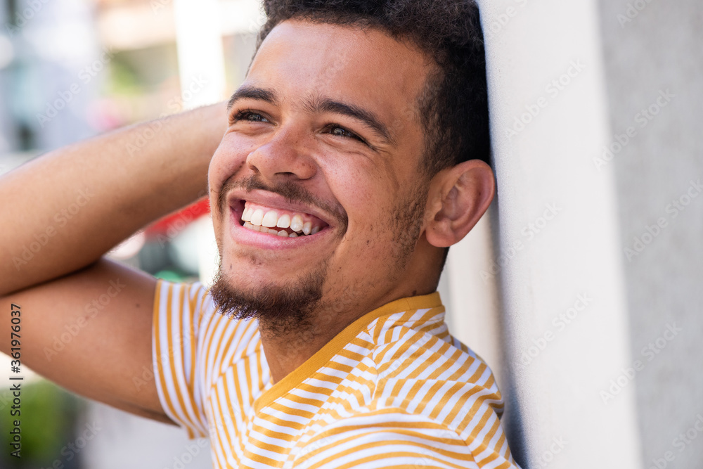 side portrait cheerful young mixed race african american man with hand behind head side portrait cheerful young mixed race african american man with hand behind head