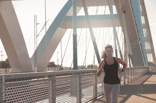 Young woman running at the Bridge © Stock Rocket