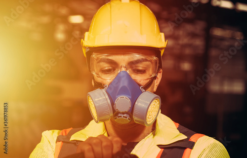 Engineers man wear protective masks to work in the factory.