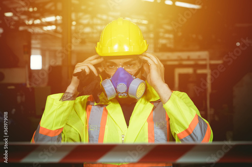 Engineers man wear protective masks to work in the factory.