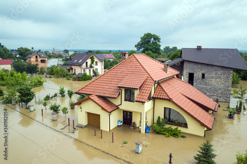 Aerial view of flooded houses with dirty water of Dnister river in Halych town, western Ukraine. © bilanol