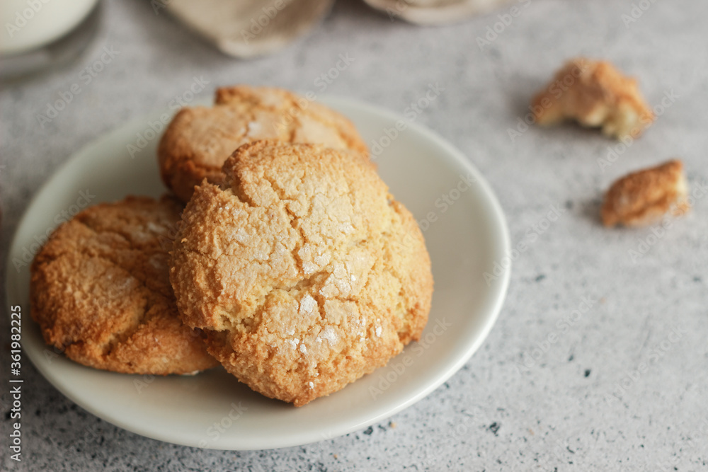Tasty almond cookies with milk. Cookies on a plate Tasty almond cookies with milk. Cookies on a plate