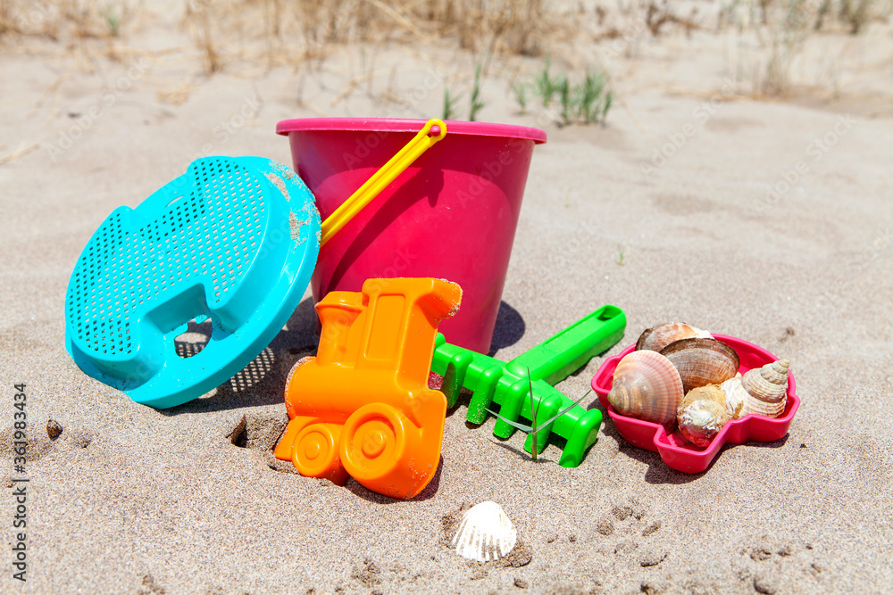 Toys for little kids on the beach on sunny day Toys for little kids on the beach on sunny day
