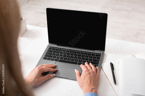 Marketing and smm. Woman works at laptop, near notebook and pen