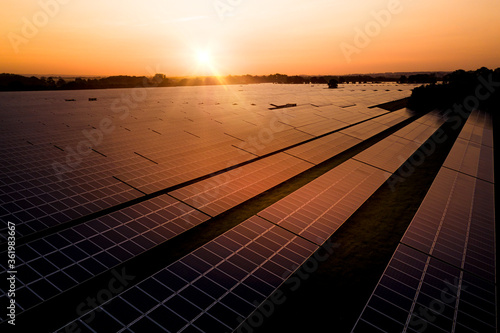 Sunrise over a modern solar farm