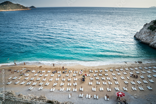 People enjoying sun and sea at the beautiful turquoise sea and sandy beach of Kaputas. aerial drone shooting. Mediterranean, Kas / Antalya – TURKEY photo