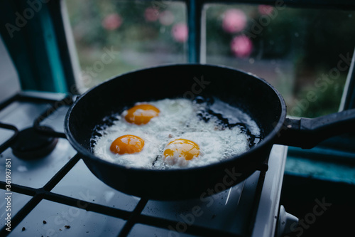 frying eggs in a pan in the village