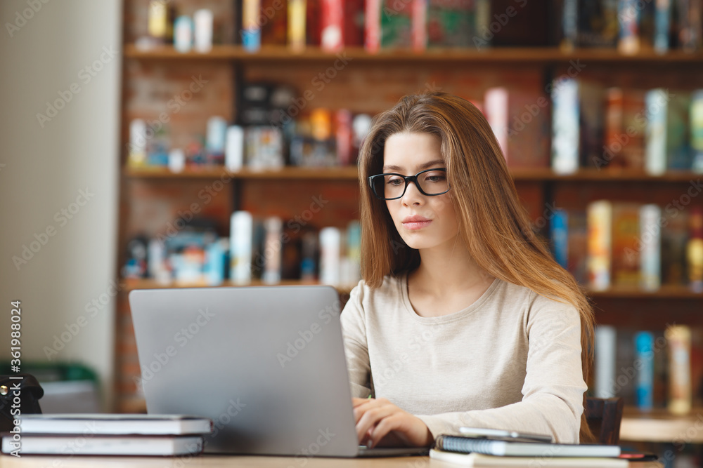 Young girl writing blog, chatting online, working on laptop Young girl writing blog, chatting online, working on laptop