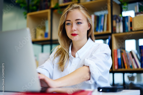 Concentrate female student watching training webinar on laptop computer improving knowledge and skills preparing for examination, business woman making researches planning startup browsing information