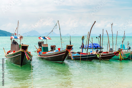 Authentic Thai long tail fishing boats docked at Thong Krut beach on a day, Koh Samui, Thailand