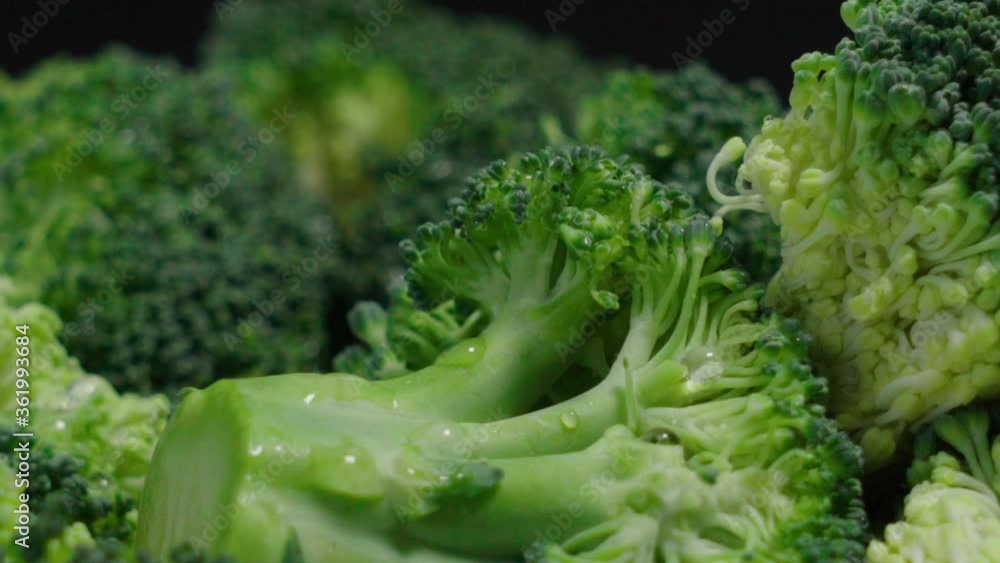 Fresh broccoli pieces on black background, Extreme Closeup Pan Right Fresh broccoli pieces on black background, Extreme Closeup Pan Right