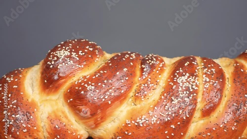 Close up of braided challah bread with sesame and poppy seeds. photo