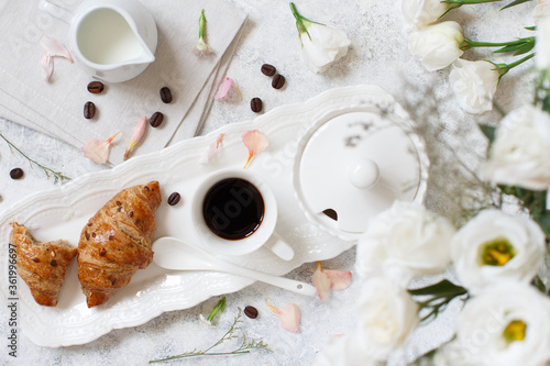 Romantic breakfast tray with coffee cup and croissant