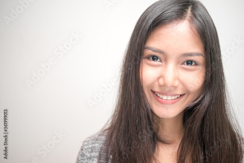 Face of happy young beautiful Asian teenage girl smiling
