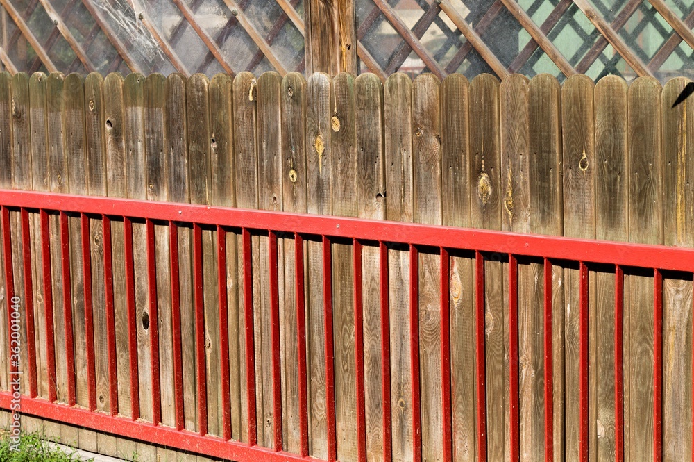 Fototapeta premium Metallic red railing with a wooden fence (Pesaro, Italy, Europe)