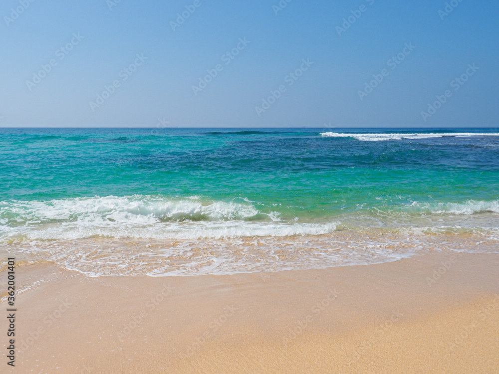Ocean waves run over the beautiful beach on coast of Sri Lanka, Mirissa. Indian ocean. Ocean waves run over the beautiful beach on coast of Sri Lanka, Mirissa. Indian ocean.