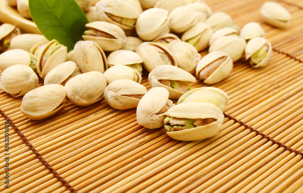 pistachios close up. Isolated on bamboo mat