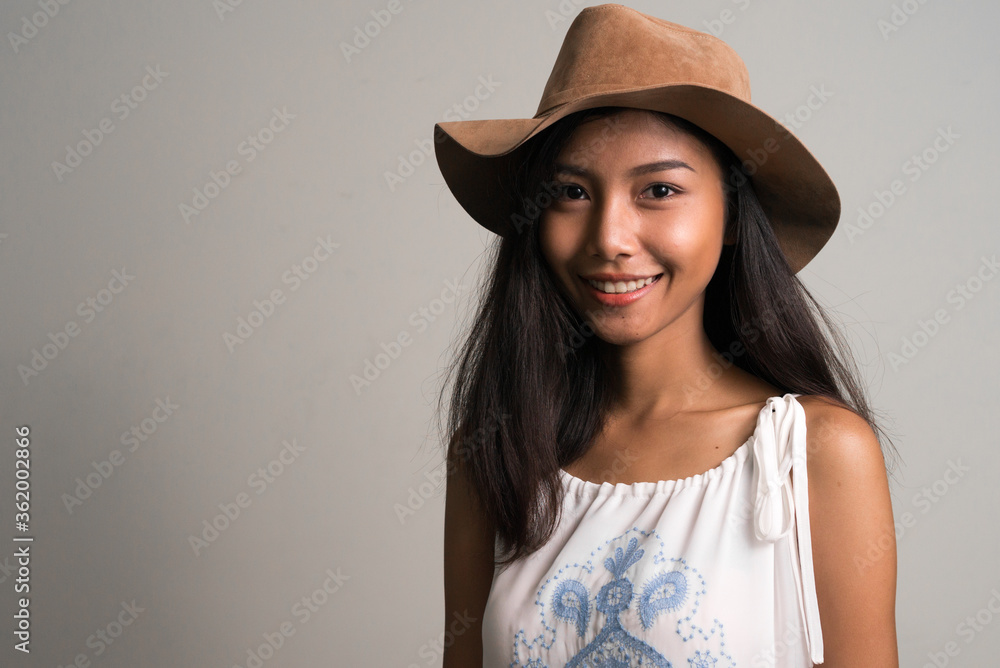 Happy young beautiful Asian teenage girl as tourist smiling Happy young beautiful Asian teenage girl as tourist smiling