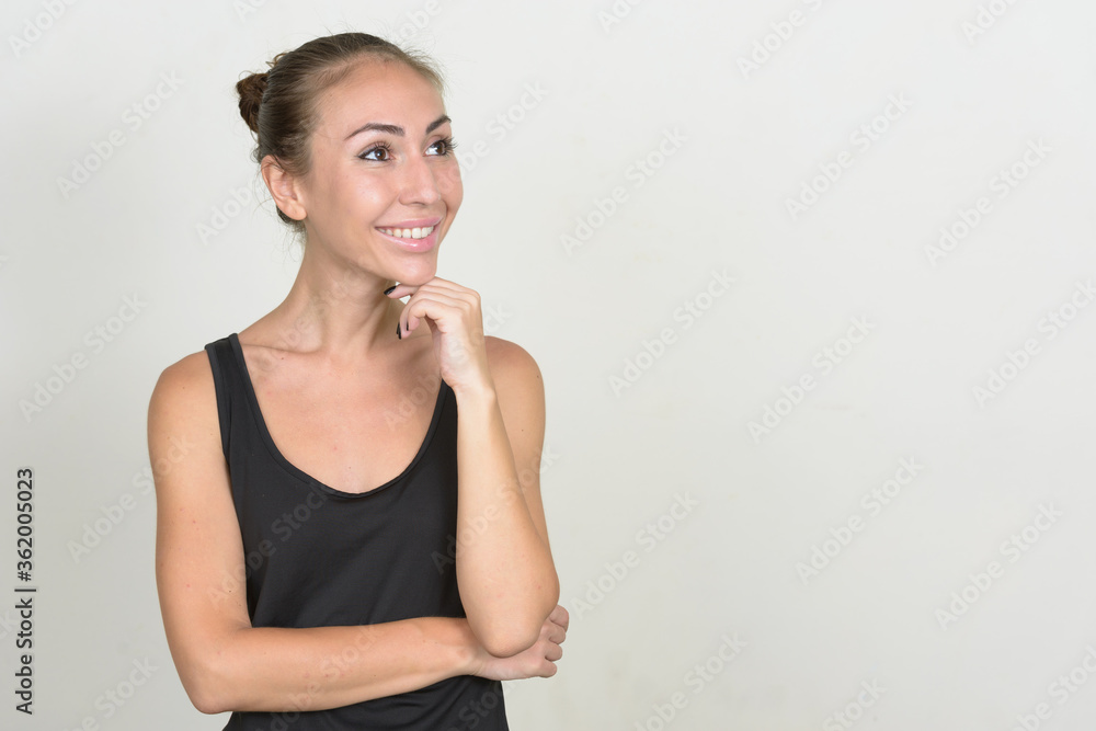 Portrait of happy young woman with brown hair thinking Portrait of happy young woman with brown hair thinking