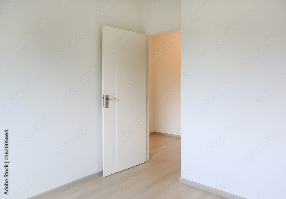 Open door in the white room of new house Open door in the white room of new house