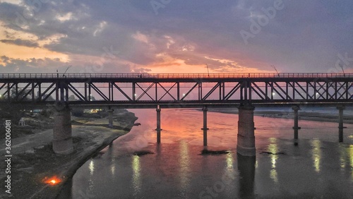 bridge at sunset over river photo