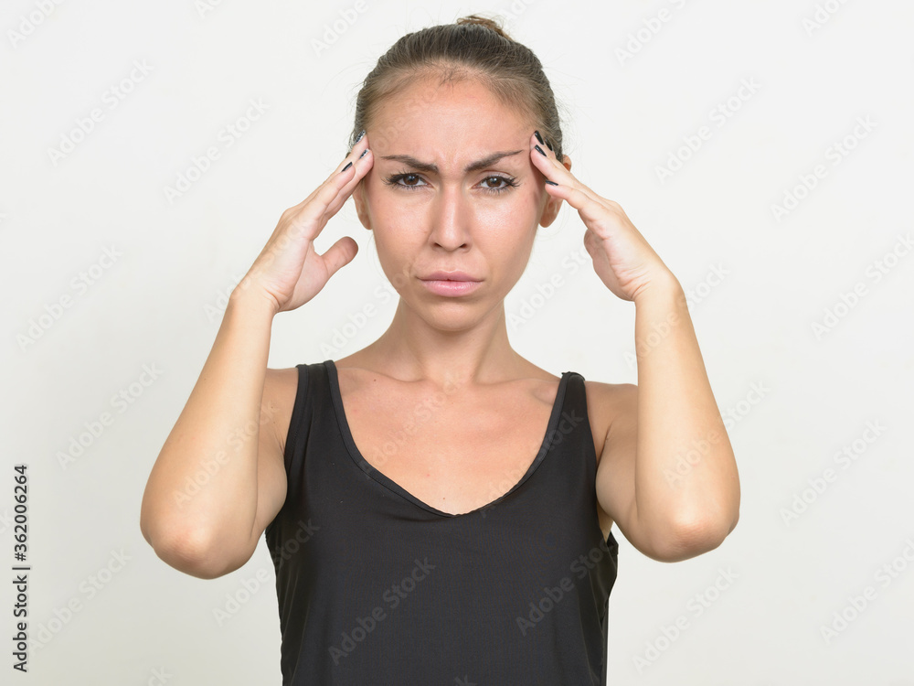 Stressed young woman with brown hair having headache Stressed young woman with brown hair having headache