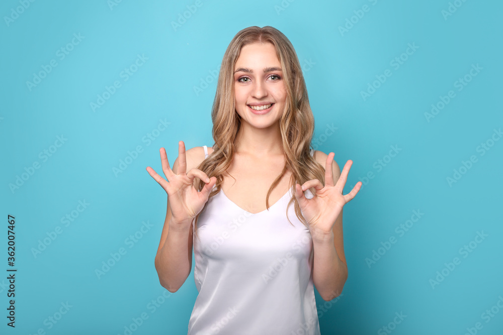 Beautiful woman using sign language on blue background. Sign language Beautiful woman using sign language on blue background. Sign language
