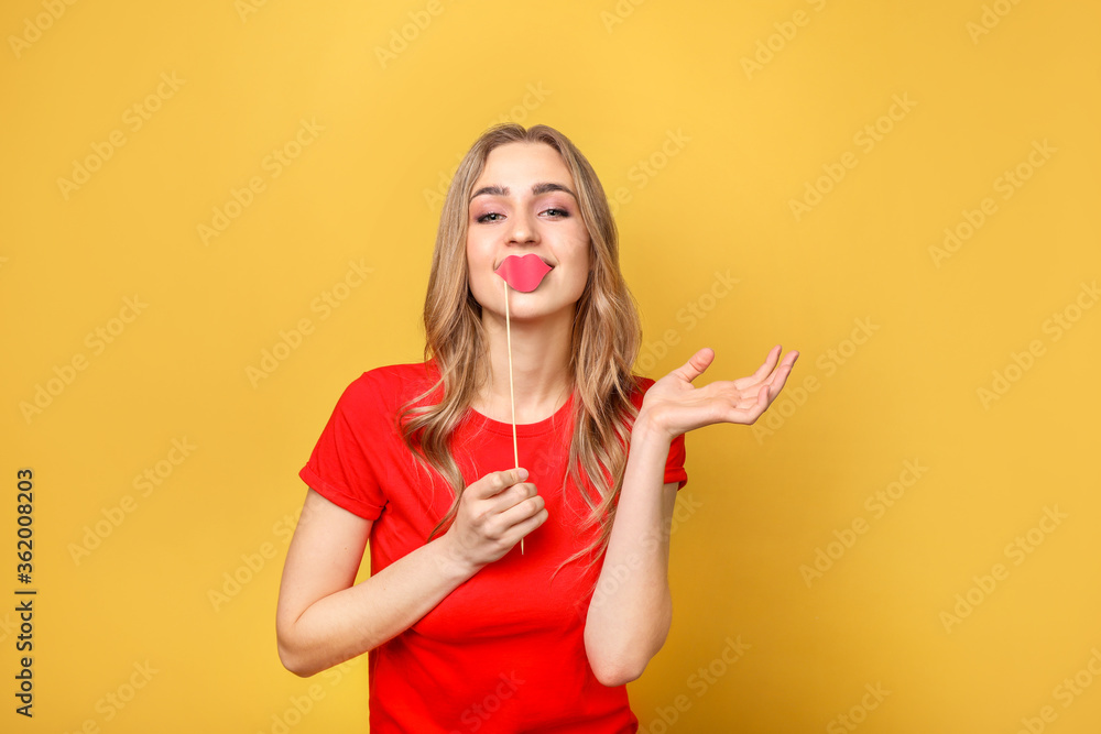 Funny woman with lips on yellow background Funny woman with lips on yellow background