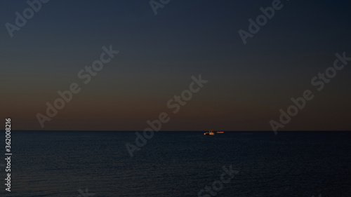 ship on the horizon in the Black Sea at sunset © dimm86
