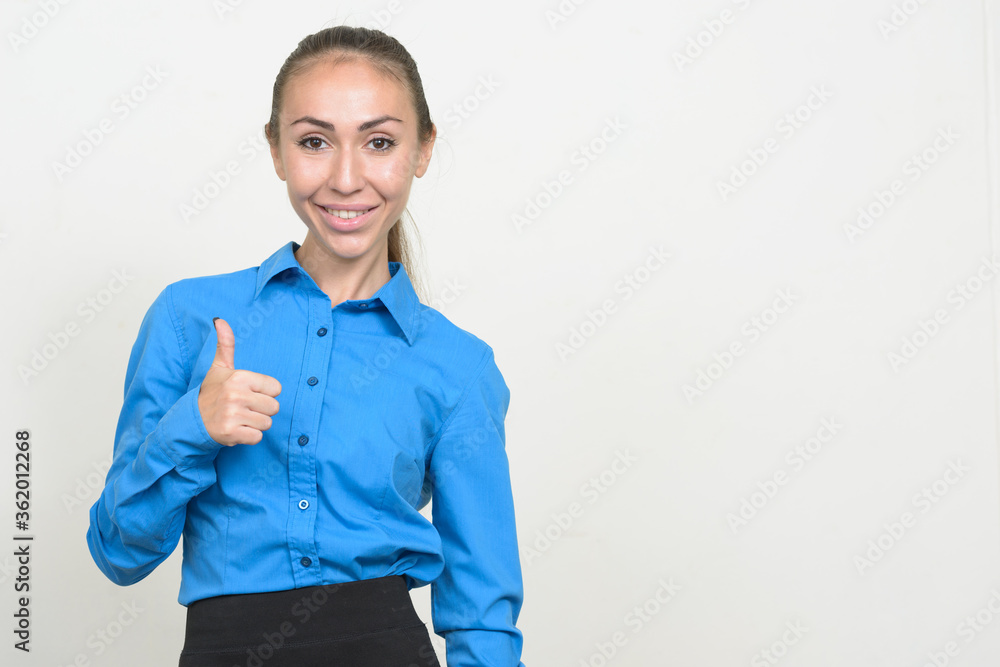 Portrait of happy young businesswoman giving thumbs up Portrait of happy young businesswoman giving thumbs up