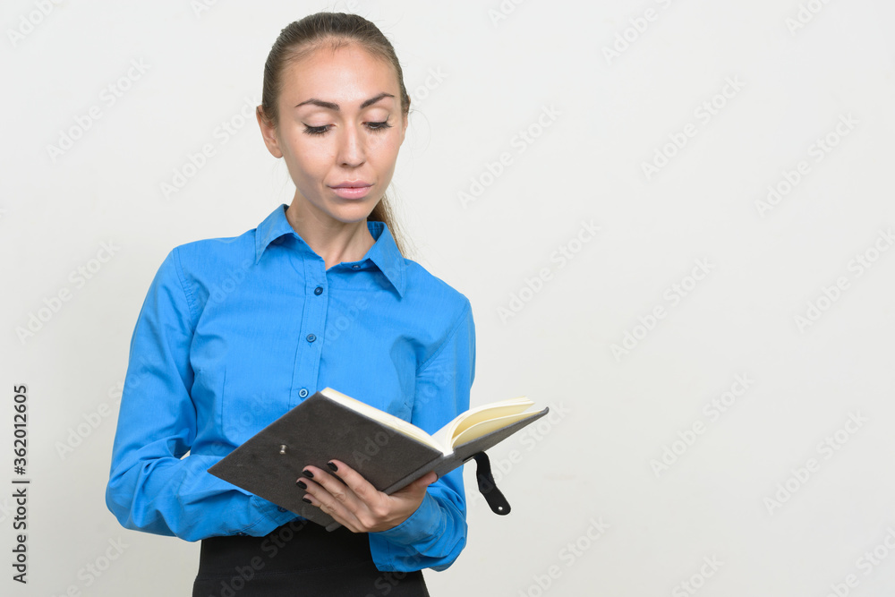 Portrait of young businesswoman with brown hair reading book Portrait of young businesswoman with brown hair reading book