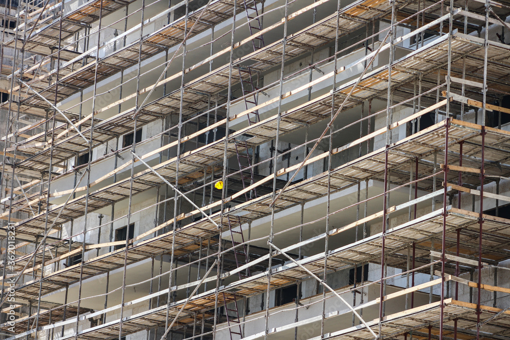 Photo of multistory high rise building with scaffolding Photo of multistory high rise building with scaffolding