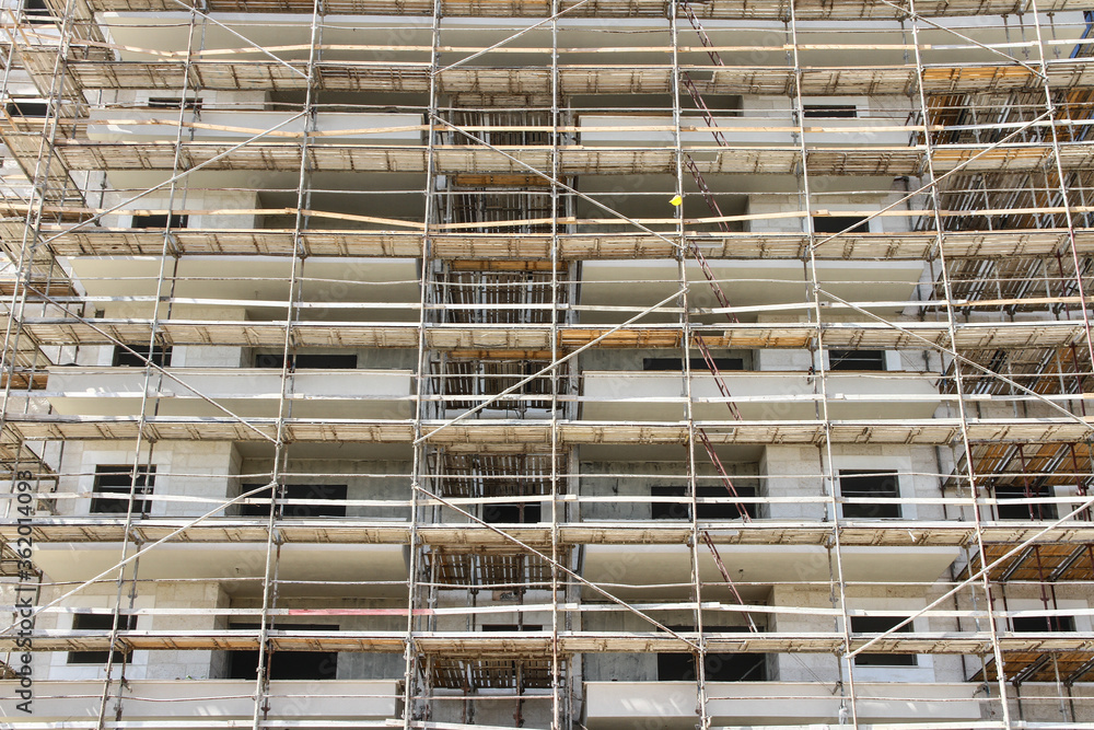 Photo of multistory high rise building with scaffolding Photo of multistory high rise building with scaffolding
