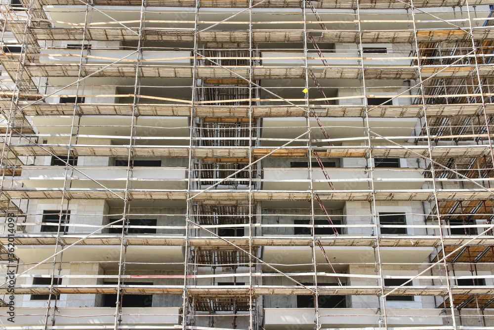 Photo of multistory high rise building with scaffolding