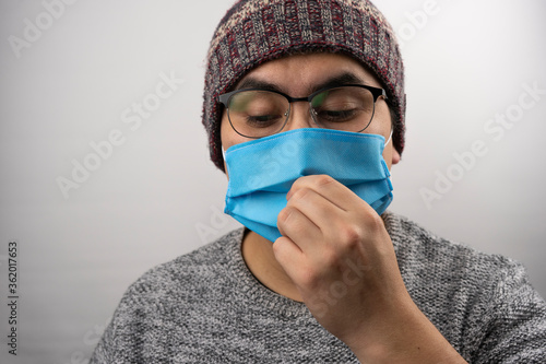 man touching mask incorrectly photo