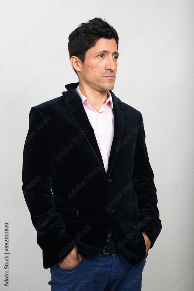 Portrait of Hispanic businessman in suit thinking Portrait of Hispanic businessman in suit thinking