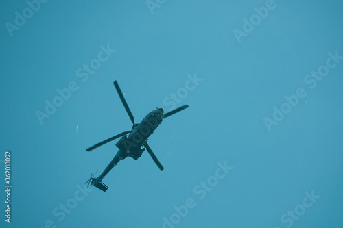 big helicopter flies in the blue sky