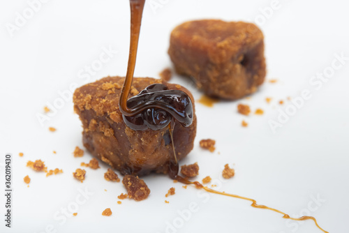 palm jaggery Indian organic Gur with Sugar Cane natural sweeteners cane syrup. Brown palm sugar. Nolen Gur, or Date palm jaggery photo