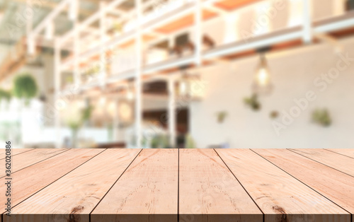 Wooden top table with bokeh light effect and blur restaurant on background © DEEP PIXEL