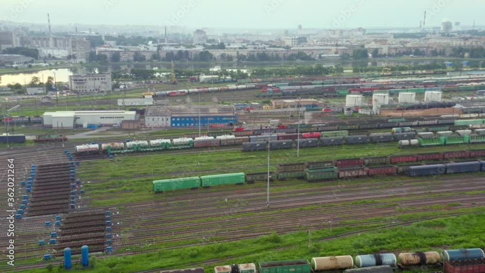 Large railway sorting station. A lot of cars, rails, buildings. View from the drone. Large railway sorting station. A lot of cars, rails, buildings. View from the drone.