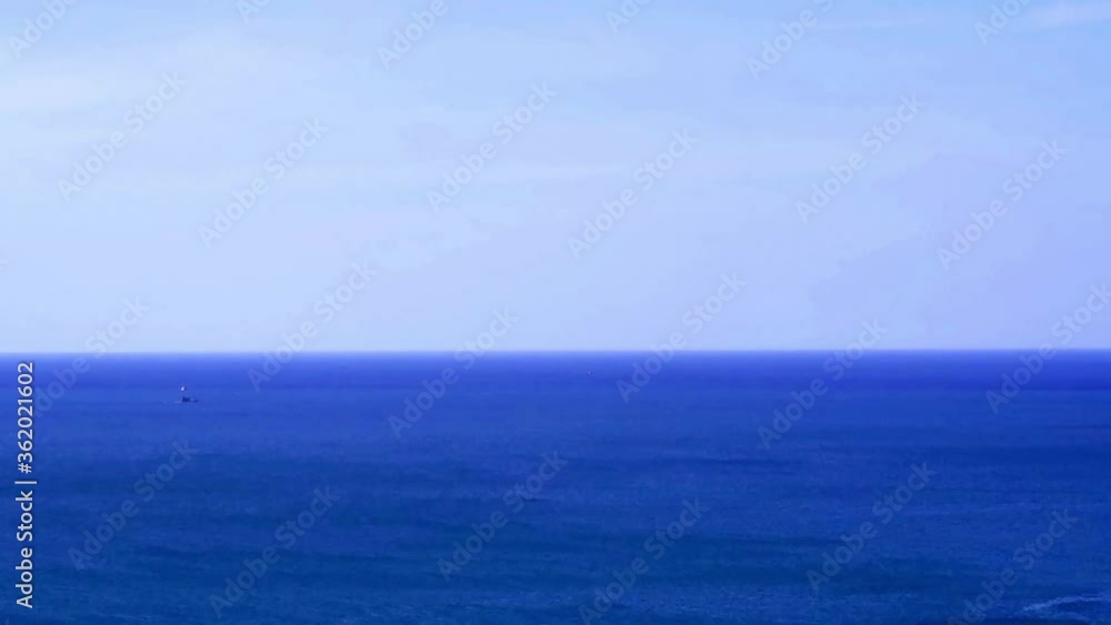 Slow Motion of dark blue water surface with calming ocean wave on cloudless cyan sky horizon background in tropical summer or spring morning sunlight & warm sun ray at island paradise, Andaman sea Slow Motion of dark blue water surface with calming ocean wave on cloudless cyan sky horizon background in tropical summer or spring morning sunlight & warm sun ray at island paradise, Andaman sea