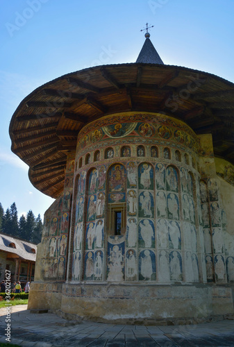 VORONET MONASTERY, BUCOVINA, ROMANIA, EUROPE, SPRING 2018. Orthodox monastery. Moldovan architectural style. Outdoor paintings, frescoes and portraits of saints with Byzantine influence